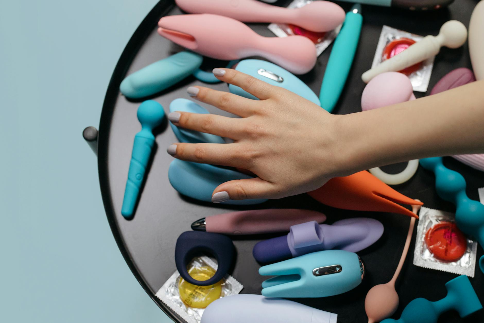 Colorful clitoral vibrators on bright yellow background showcasing design variety