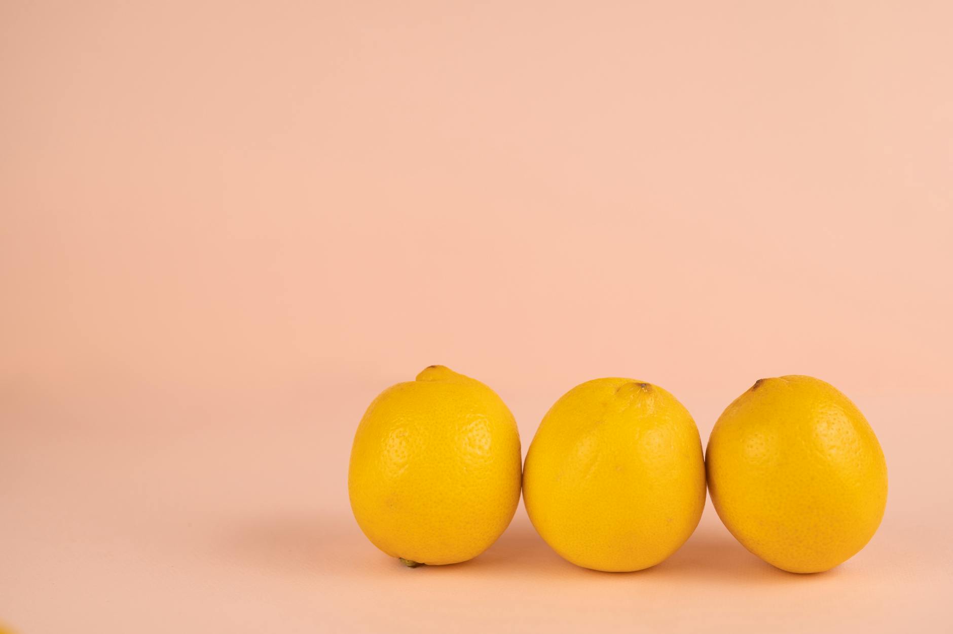 Bright yellow lemons on a pastel background, representing fresh sensations and Hello Nancy's lemon-inspired design